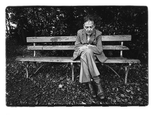 A black and white image of Ivan Blatny sitting on a bench
