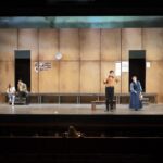 5 opera singers on stage - the set is an opera rehearsal room