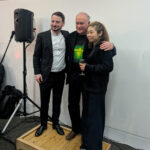 Colin Matthews, Olivier Stankiewicz and Elim Chan posing for a photo on a small platform