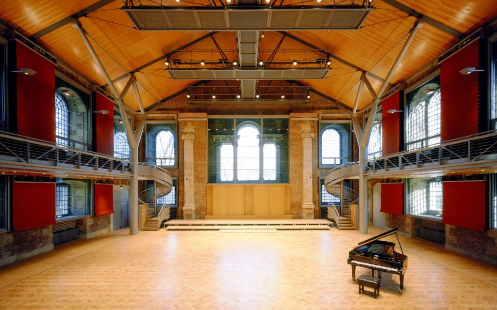 An empty hall with a grand piano in it
