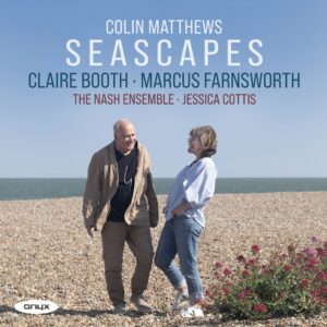 Colin Matthews and Claire booth chatting together on a pebbly beach