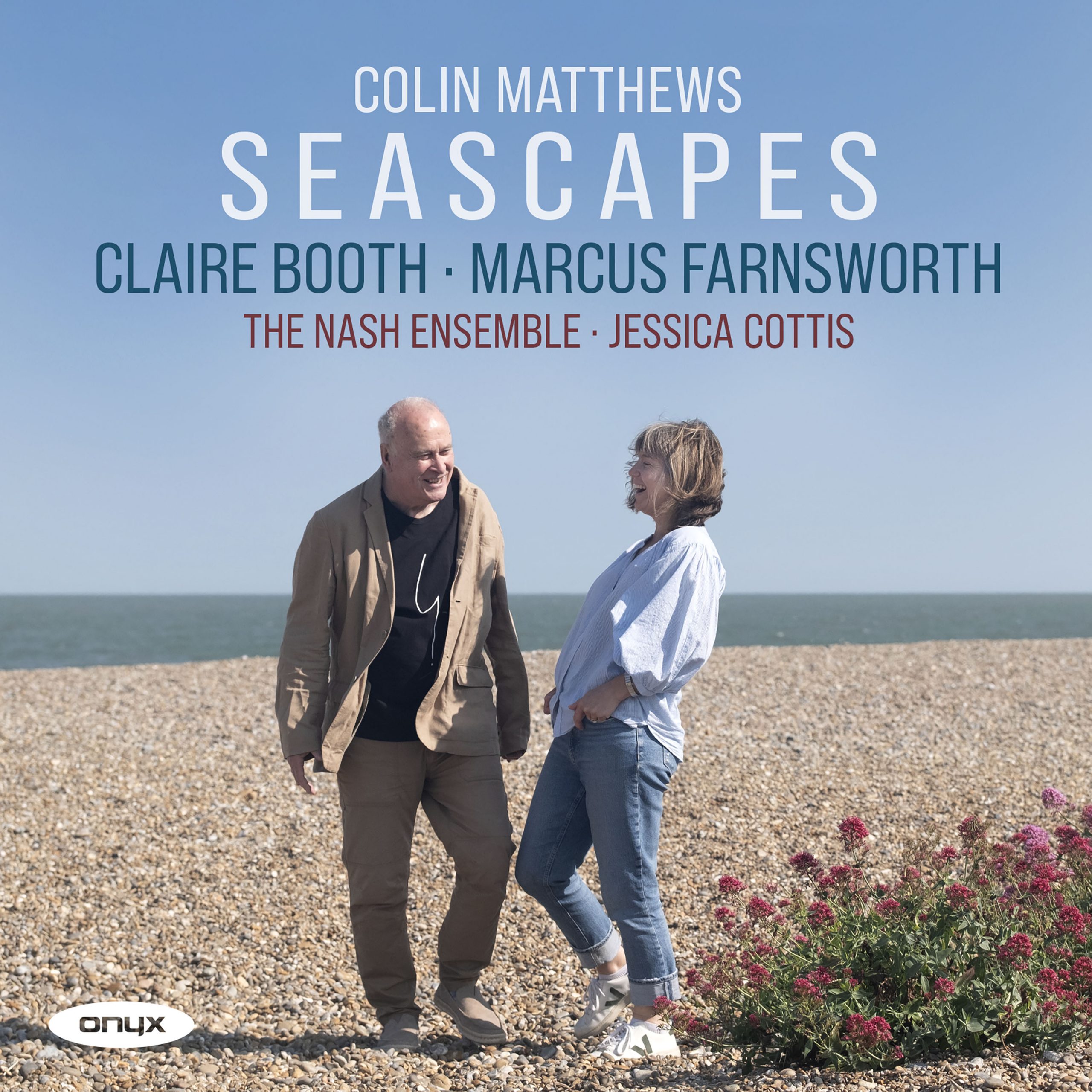 Colin Matthews and Claire booth chatting together on a pebbly beach