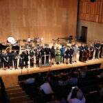 Around 25 musicians and composers line up to take a bow on stage at the Snape Maltings Concert Hall